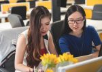 shallow focus photography of two women doing work in table